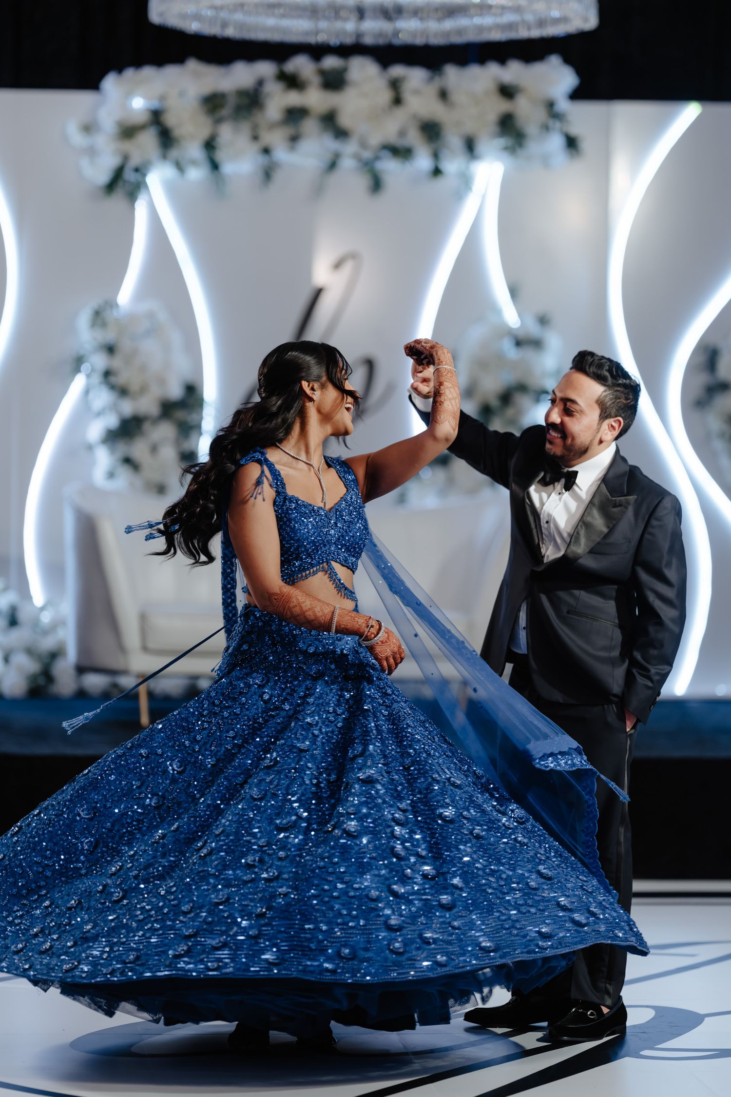 Romantic dance sequence featuring a flowing blue sparkly gown against modern white lighting design.