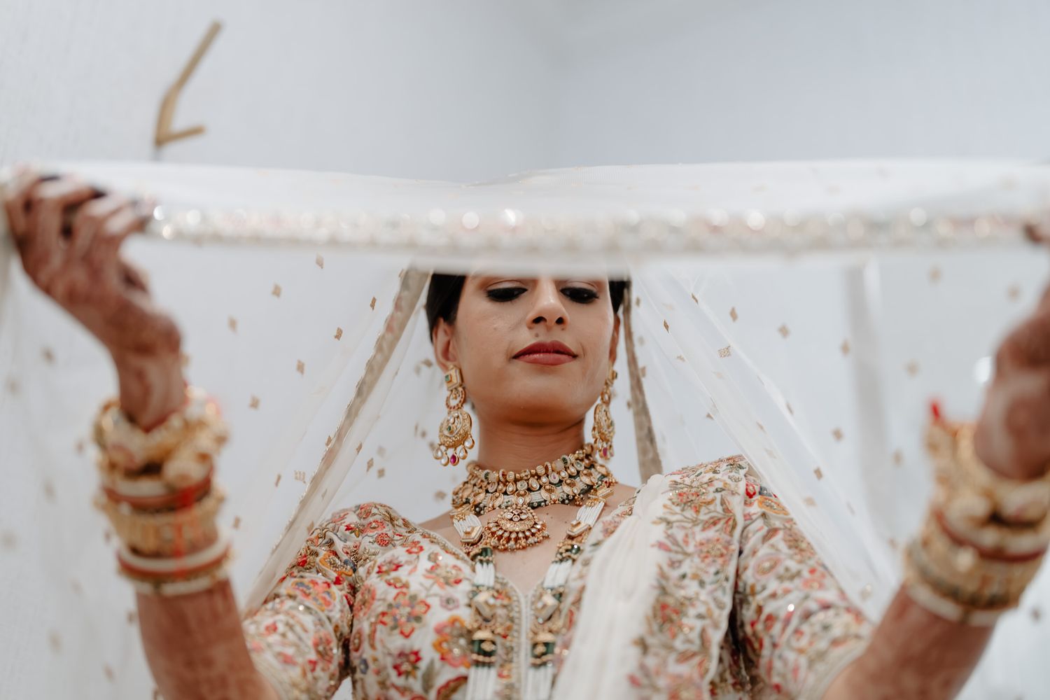 Traditional Indian bridal jewelry and attire showcased in an artistic close-up photograph.
