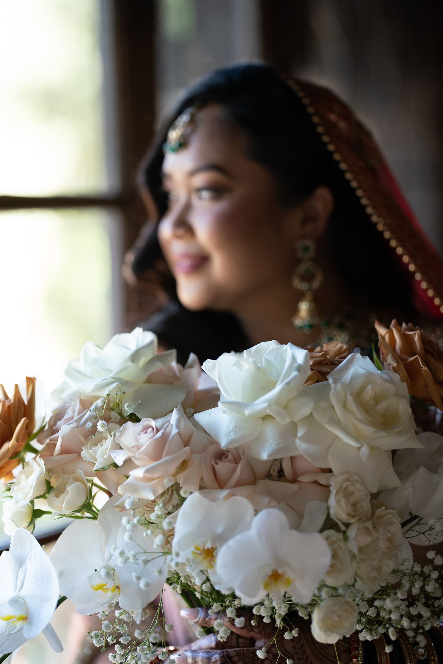 White orchids and roses create an elegant floral arrangement in soft focus.