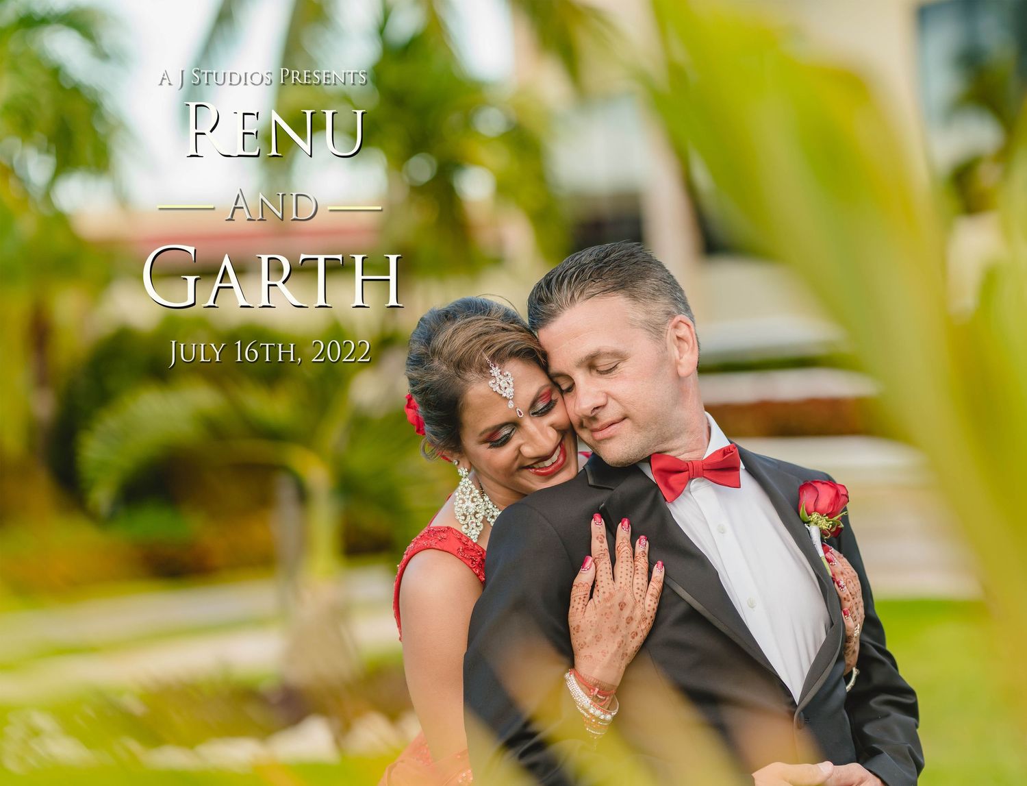 A romantic couple embraces outdoors surrounded by lush tropical palm trees and greenery on their wedding day.