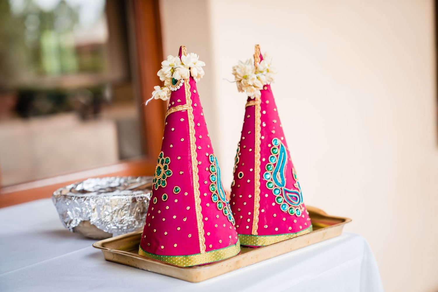 Pink watermelon-shaped cake slices decorated with chocolate chips arranged on wooden serving boards.