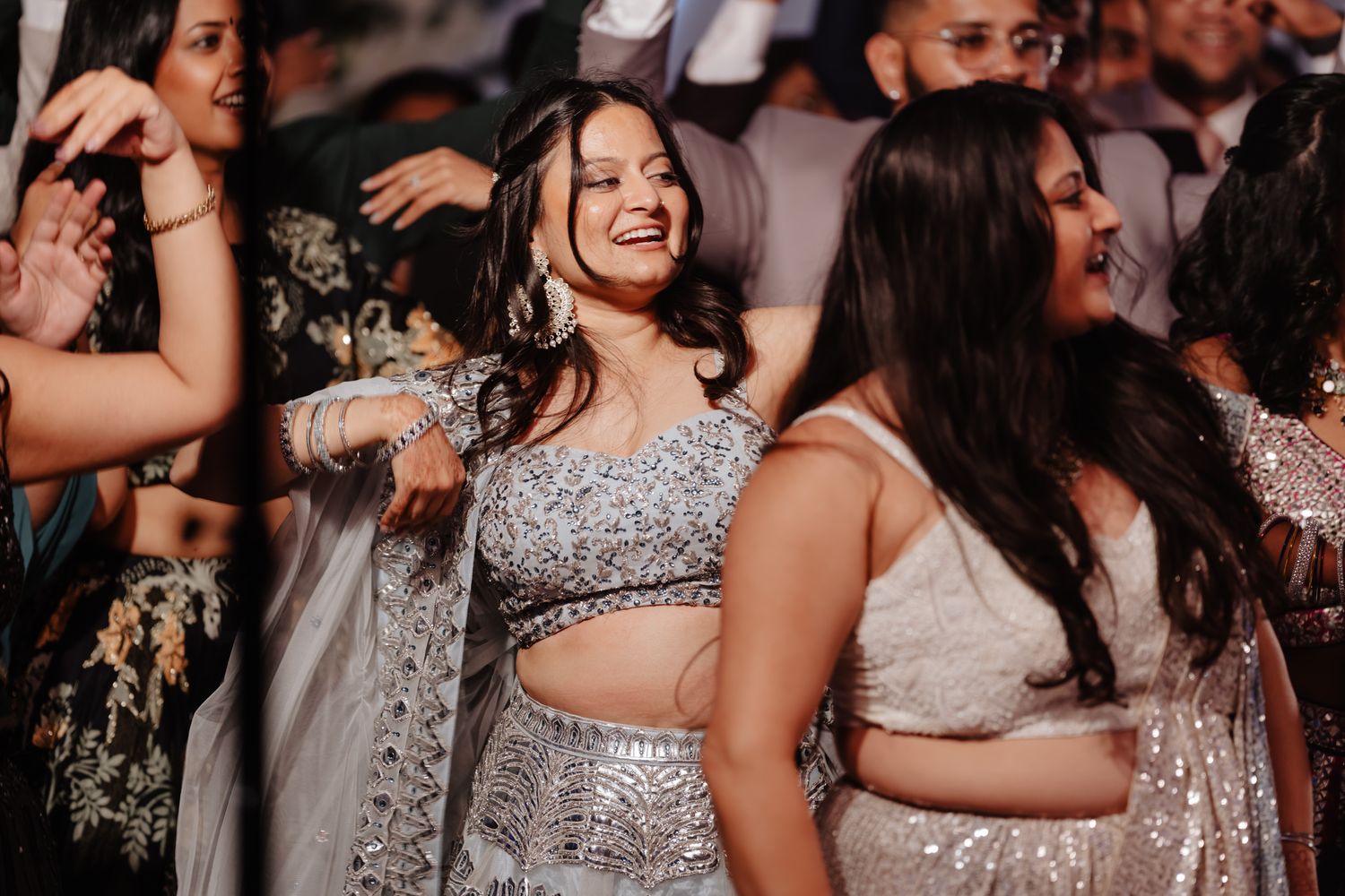 Celebration scene with guests in glamorous silver and sparkly formal wear.