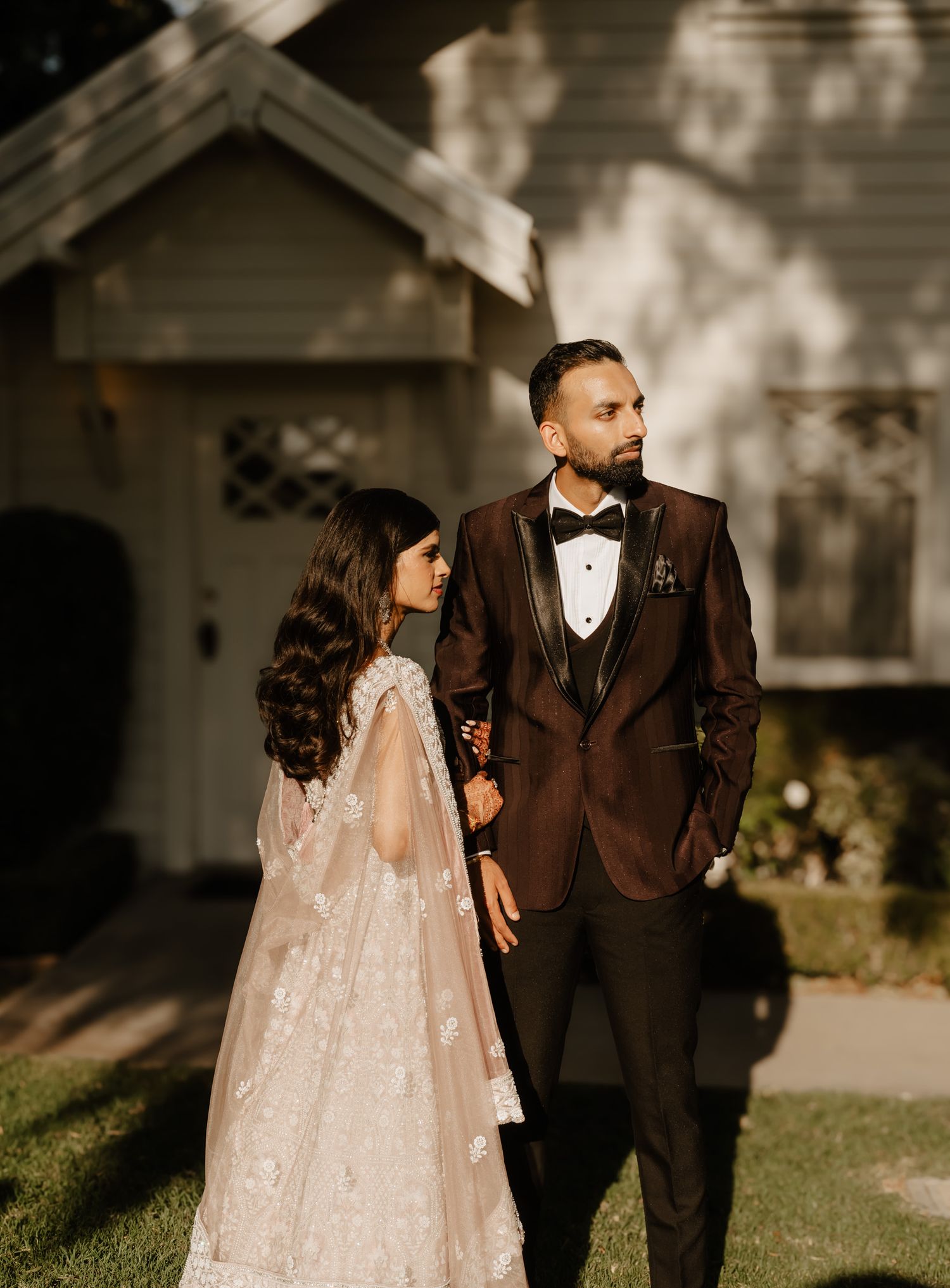 A romantic outdoor wedding photo series showing a couple in a brown tuxedo and sparkly white dress against a sunlit backdrop.