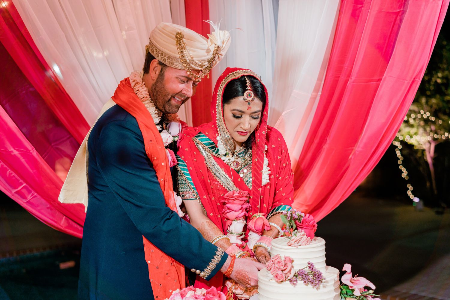 Wedding ceremony setup with pink and white draped fabric creating an elegant backdrop for a celebration.