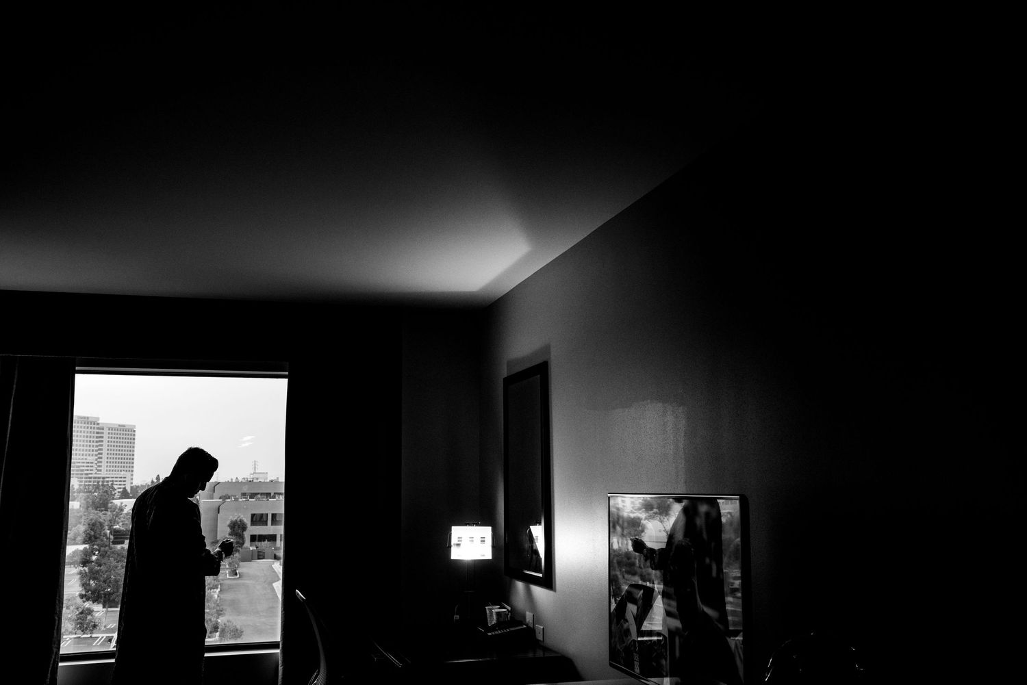 Black and white architectural photograph showing a dramatic contrast of light and shadow in an interior space.
