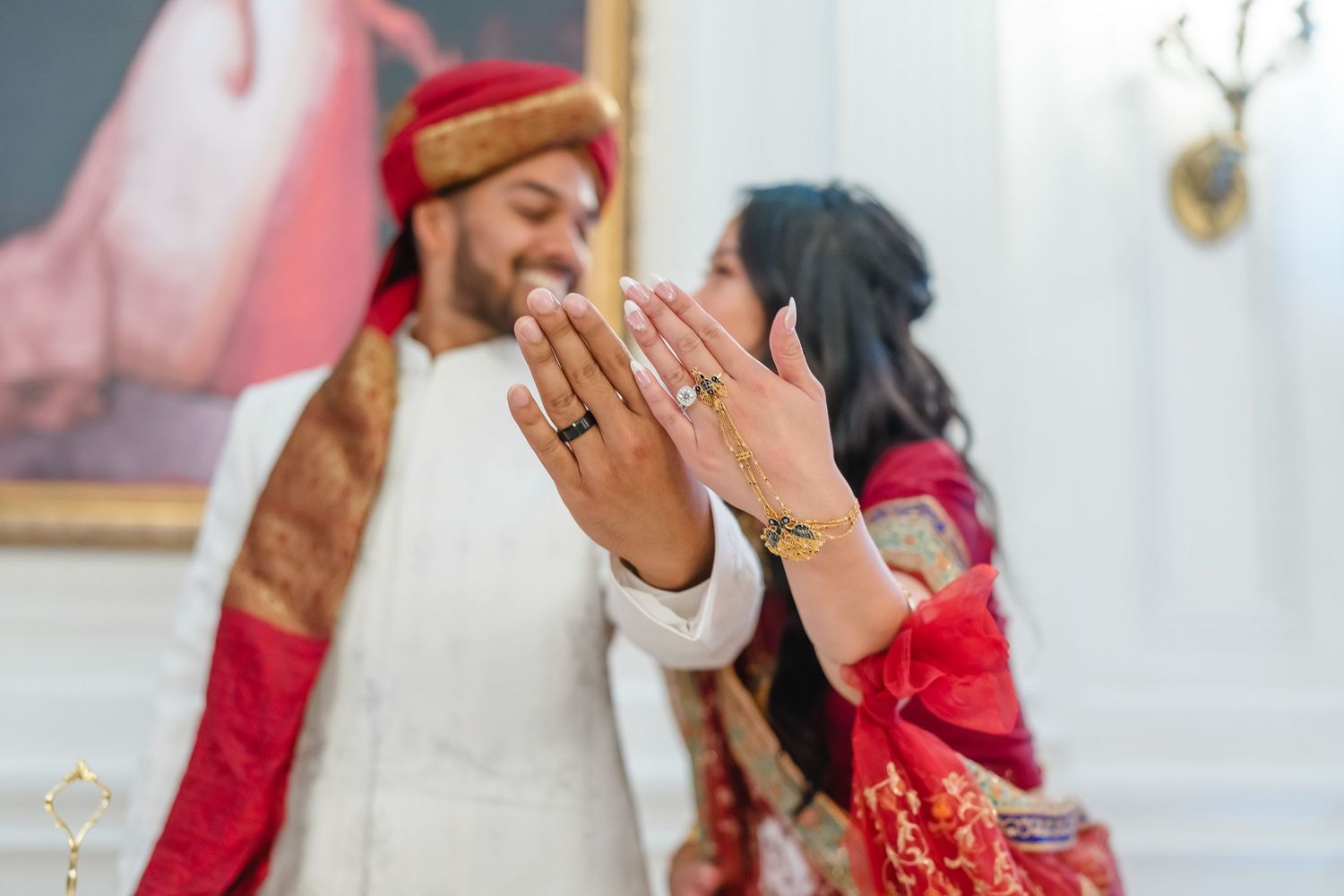 A joyful moment during an Indian wedding ceremony with the couple sharing laughter.