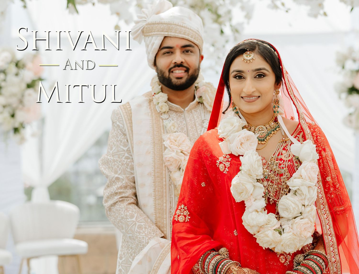 Shivani and Mitul smiling in traditional Indian wedding attire, bride in red lehenga with floral garland.