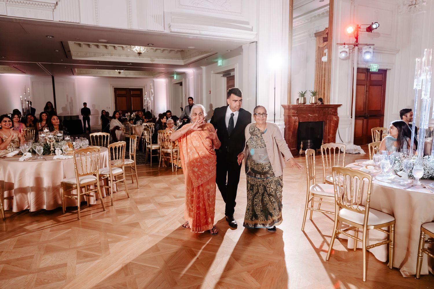 Wedding reception venue with elegant table settings and chairs arranged in a spacious ballroom.
