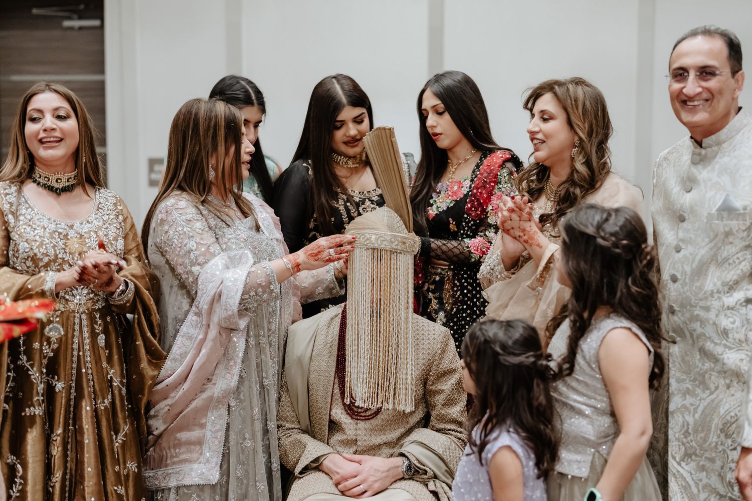 Wedding guests celebrate and dance together during a joyful reception in formal attire.