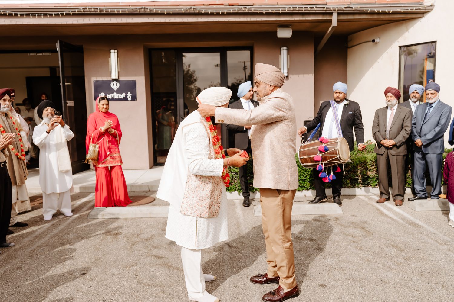 Wedding guests gather in a reception hall to celebrate with the newlyweds during an intimate ceremony.