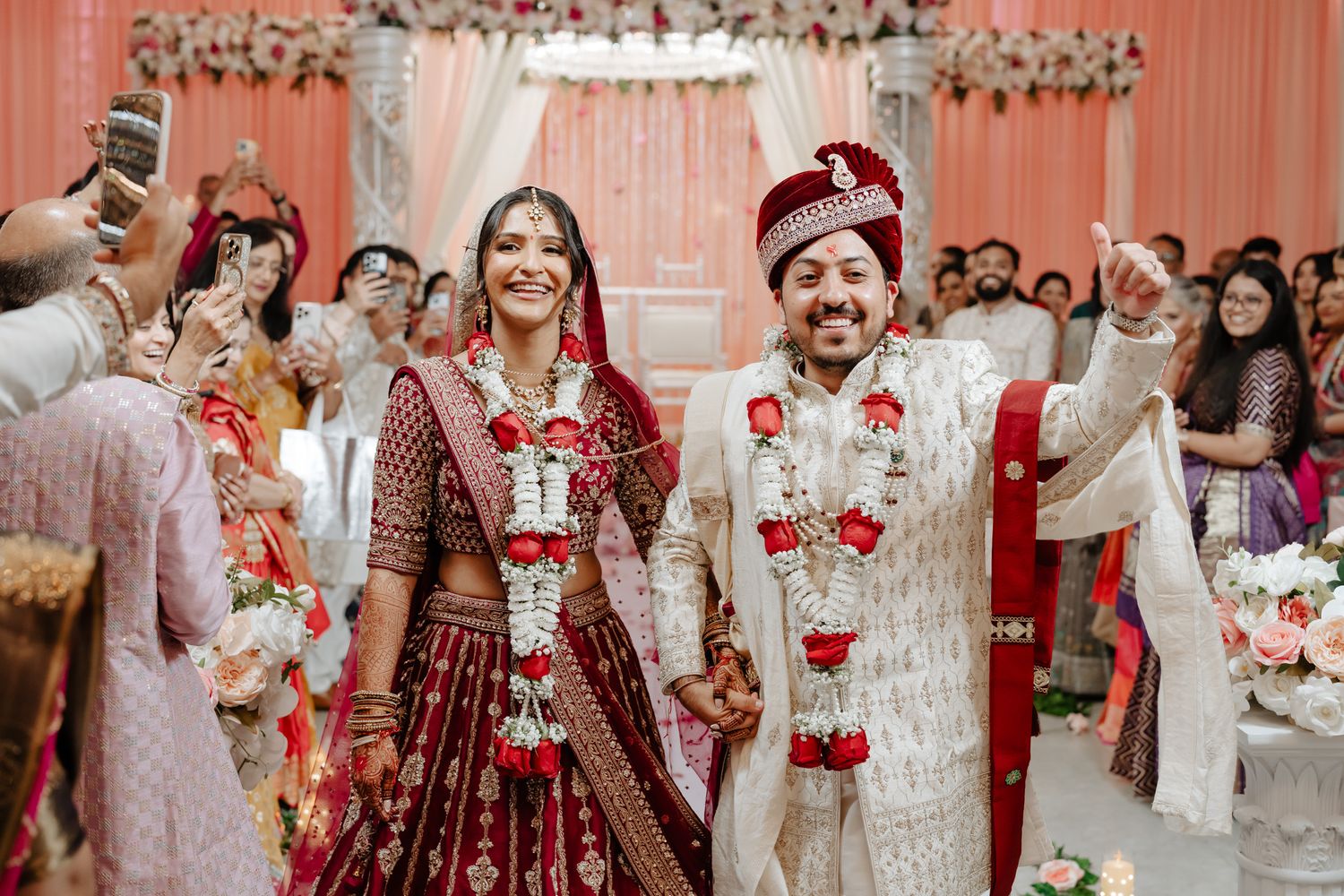 Traditional Indian wedding ceremony setup with red and white decor and floral arrangements.