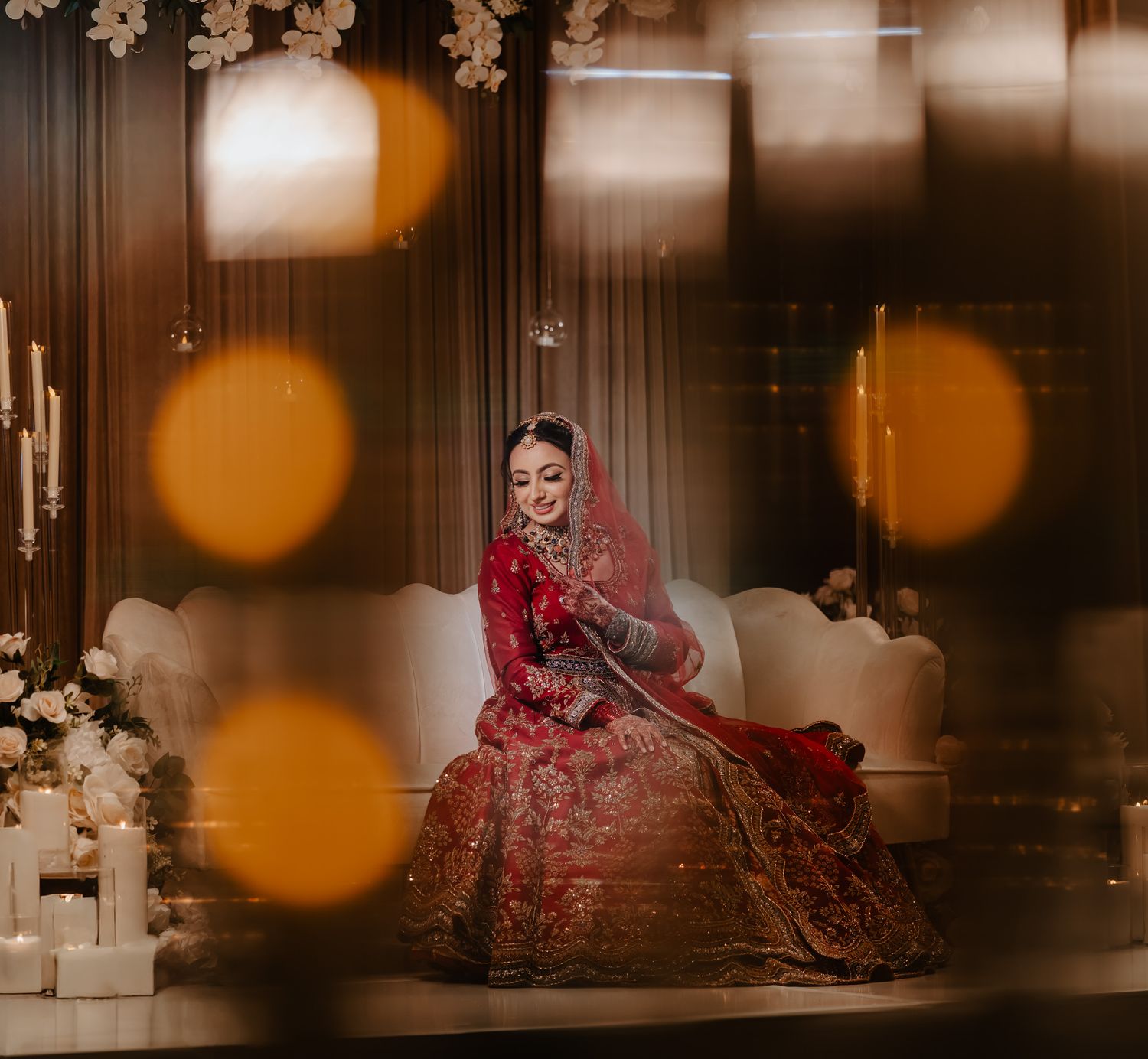 Elegant Indian wedding photography with warm bokeh lighting effects and romantic atmosphere.