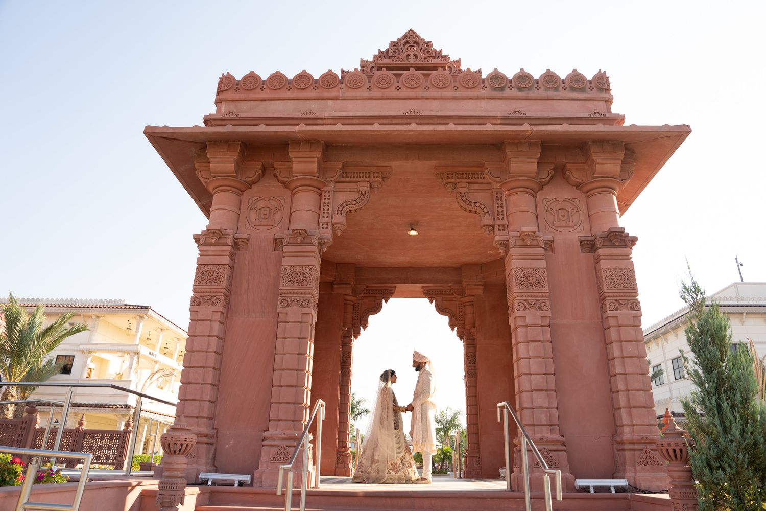 Traditional Indian temple architecture with ornate stone carvings and arched doorways.