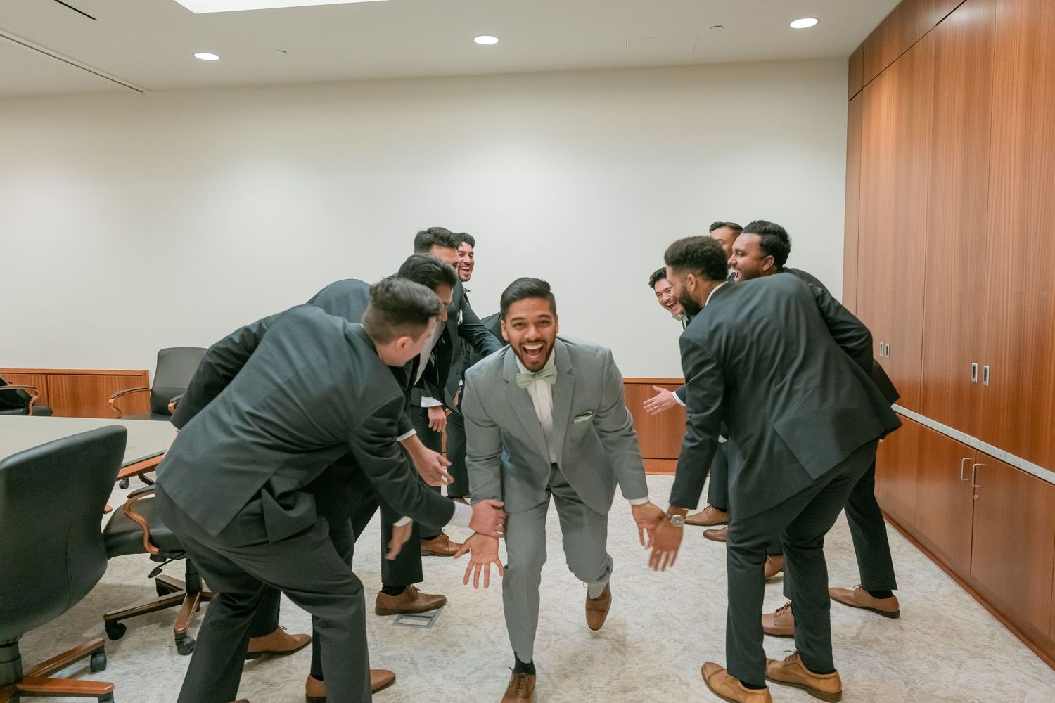 A sequence of photos showing business professionals stretching and exercising in an office hallway.