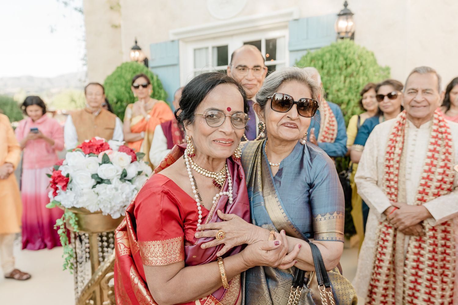 A collage of wedding celebration photos showing guests outdoors enjoying festivities in colorful attire.