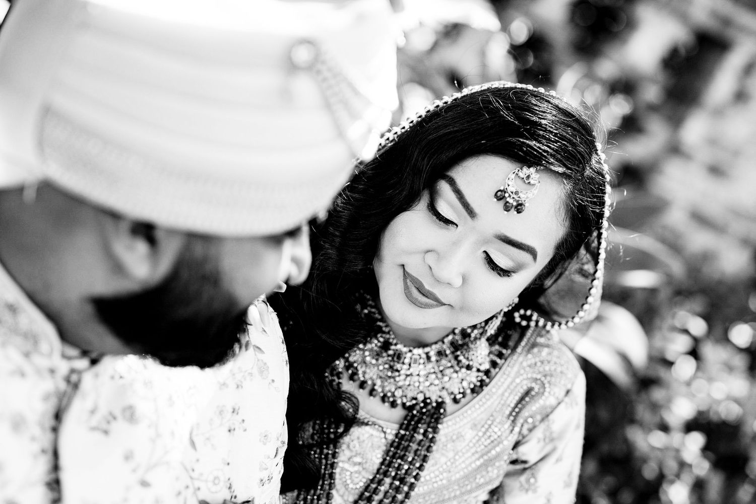 Black and white portraits of a traditional Indian bride wearing ornate jewelry and makeup.