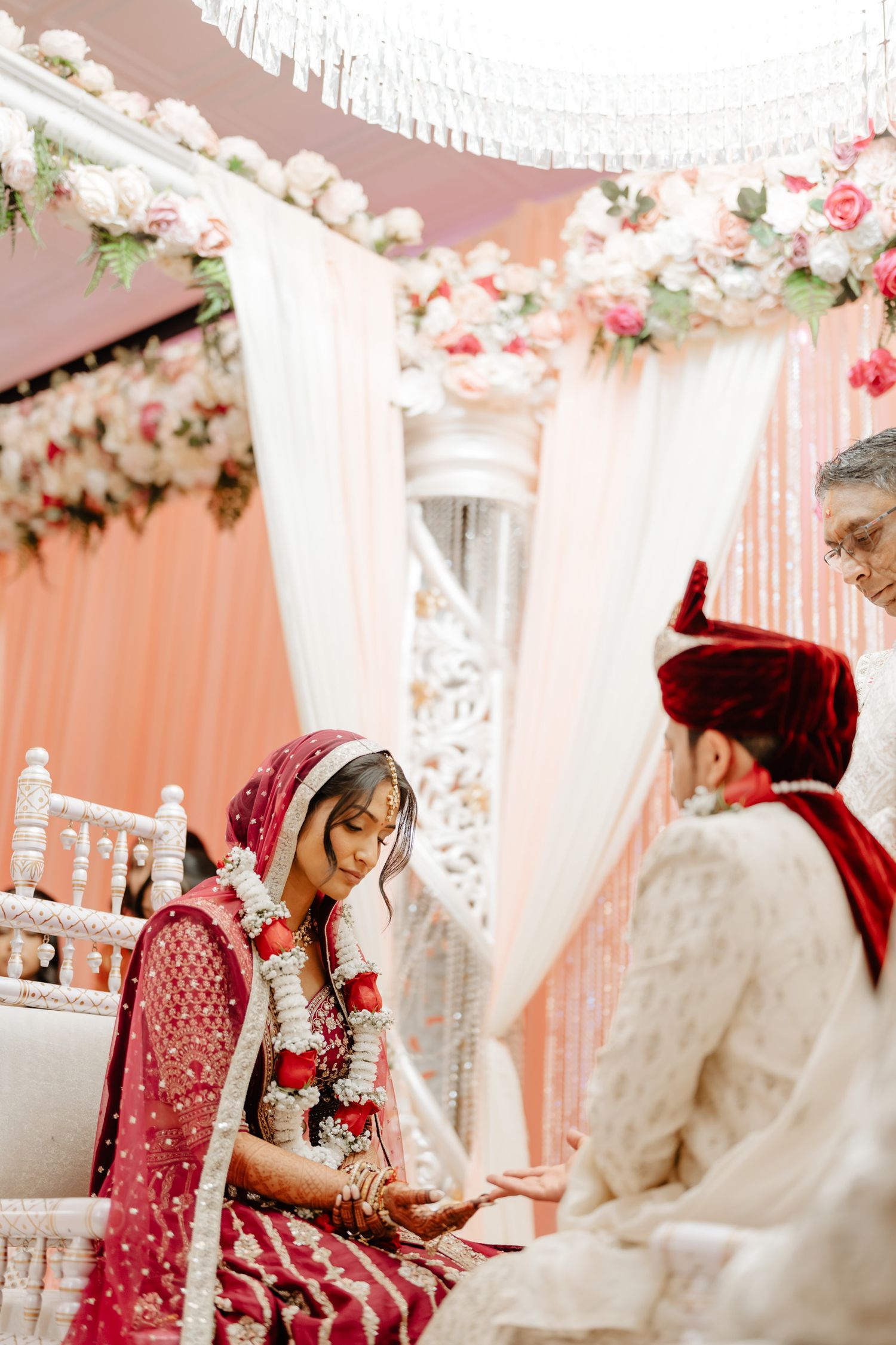 Traditional Indian wedding ceremony setup with pink and white decor and floral arrangements.