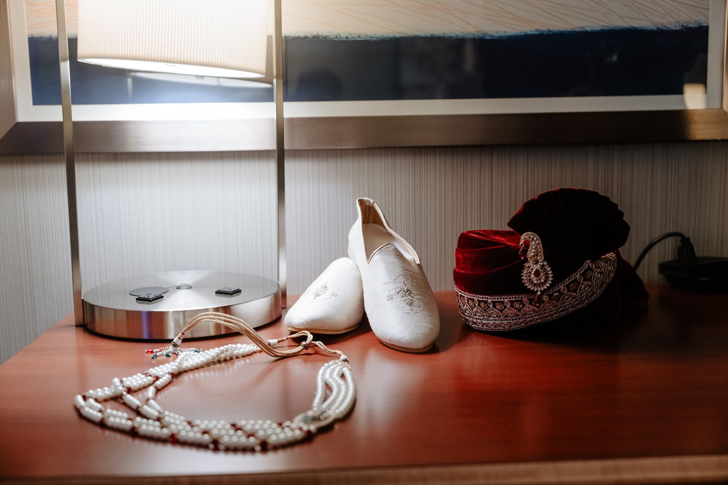 Elegant bridal accessories including jewelry, shoes, and decorative items arranged on a wooden surface.