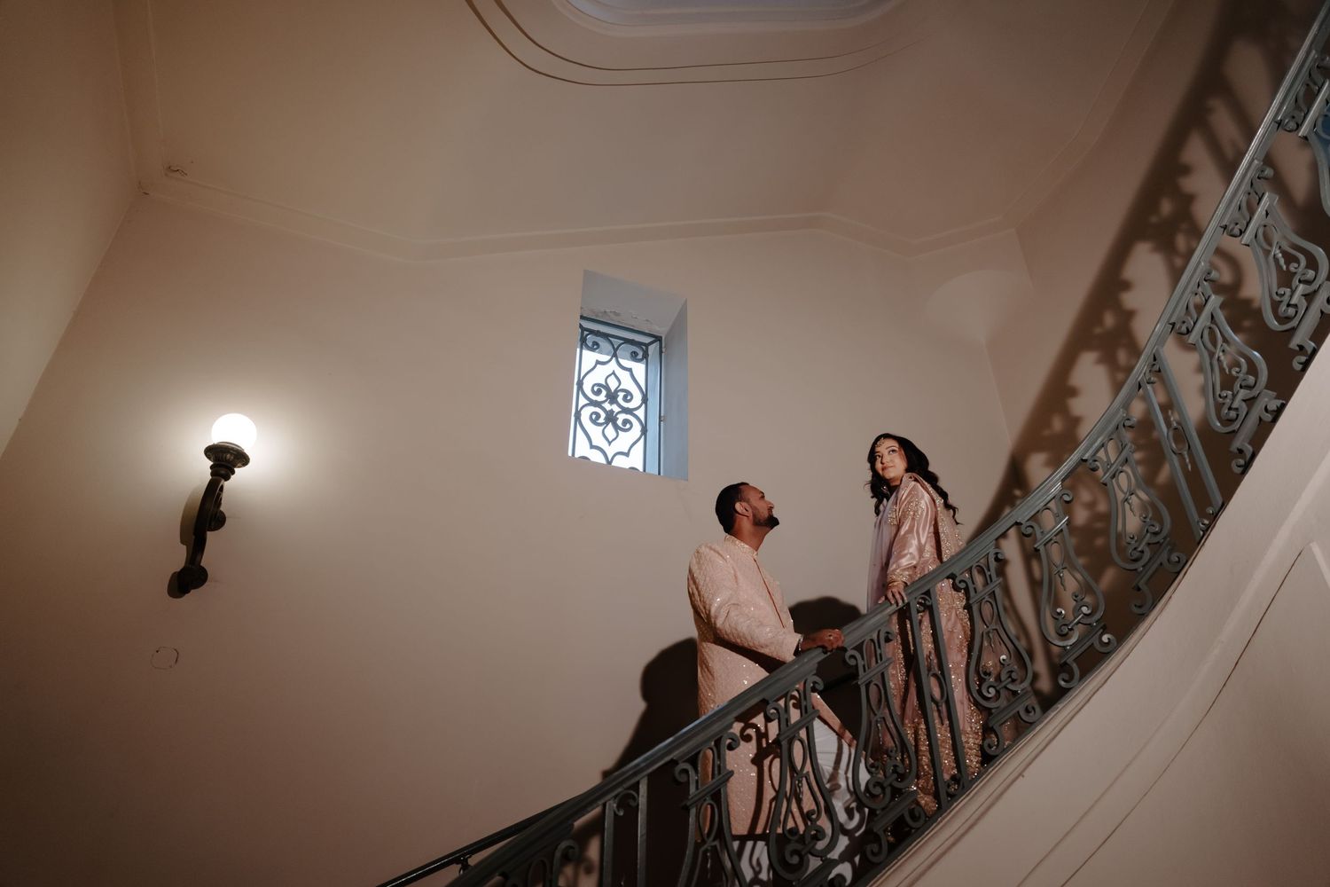 Elegant bridal portrait series showing delicate details of lace and veil in a historic stairwell setting.