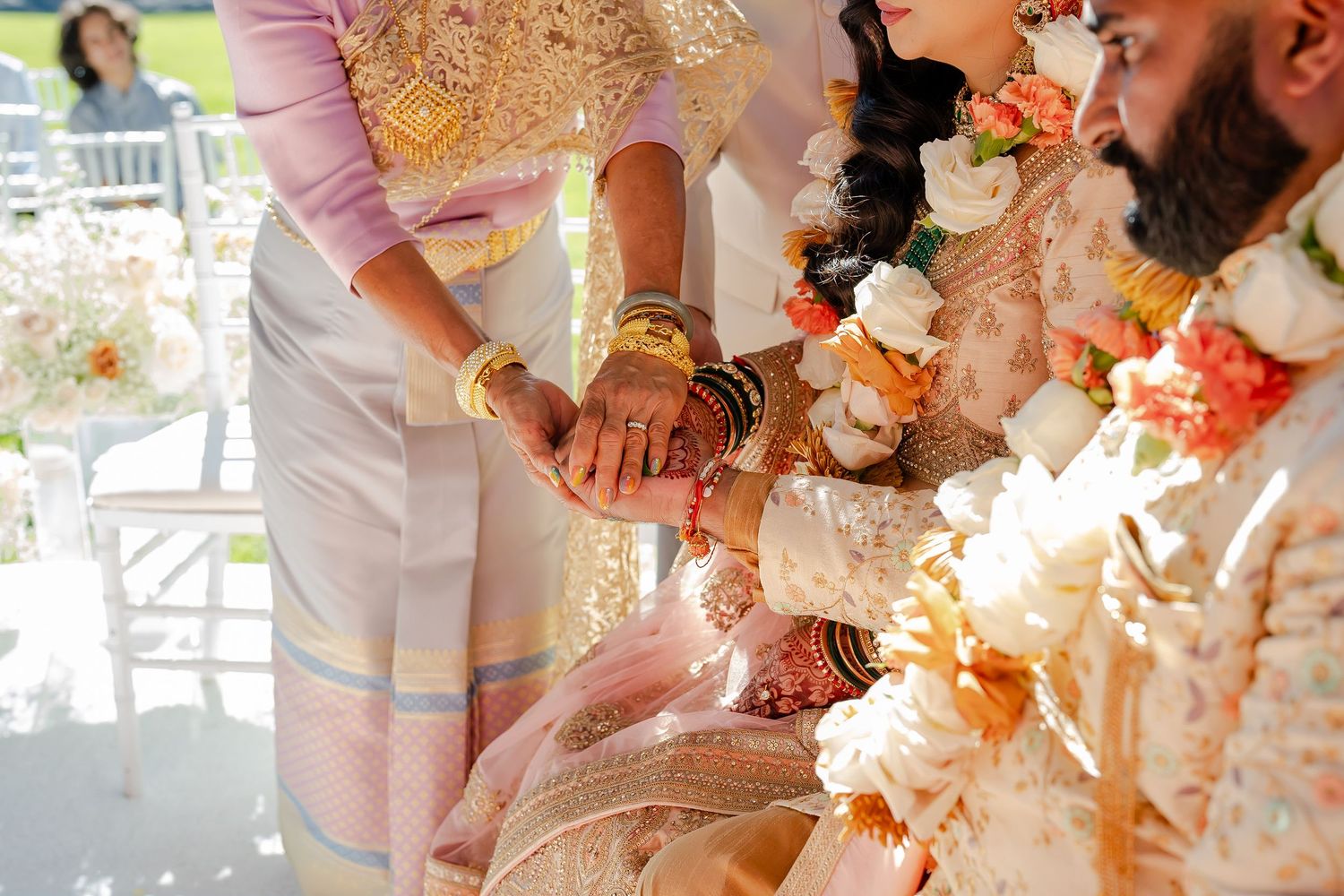 Wedding cake being smashed between a couple's hands in a playful cake-smashing tradition.