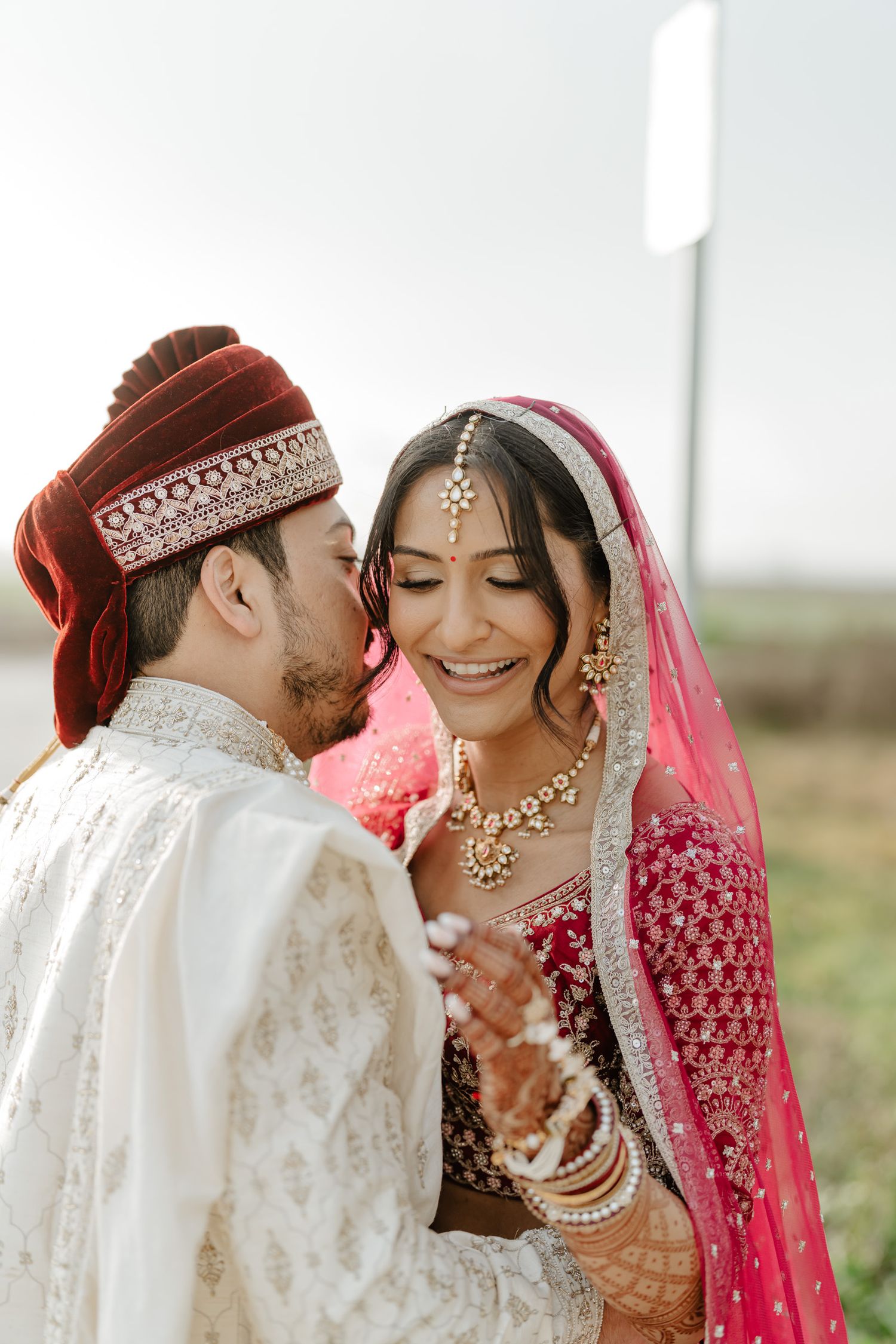Intimate wedding portraits capturing tender moments between newlyweds in traditional attire.