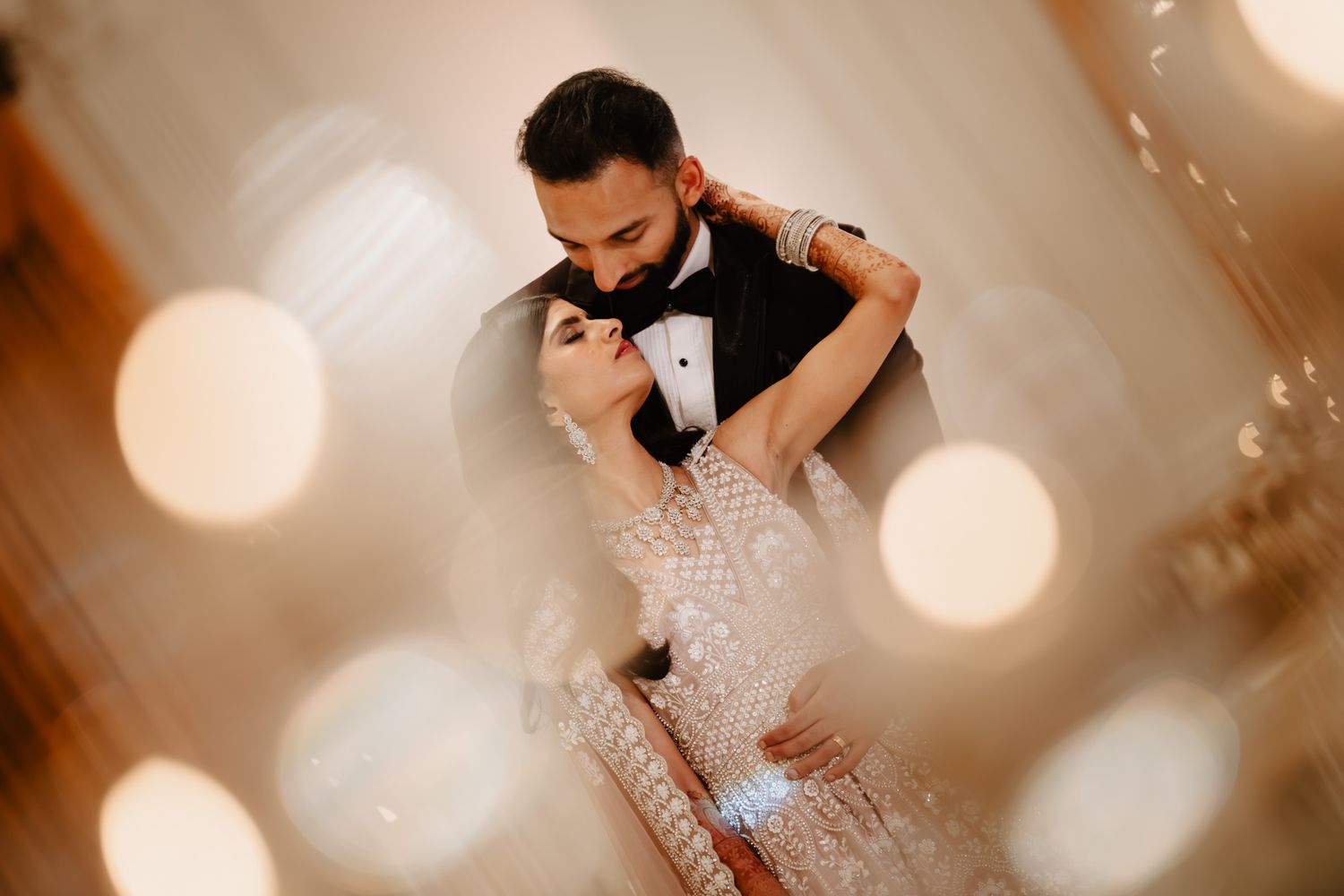 Intimate wedding moments captured with soft bokeh lighting effects.