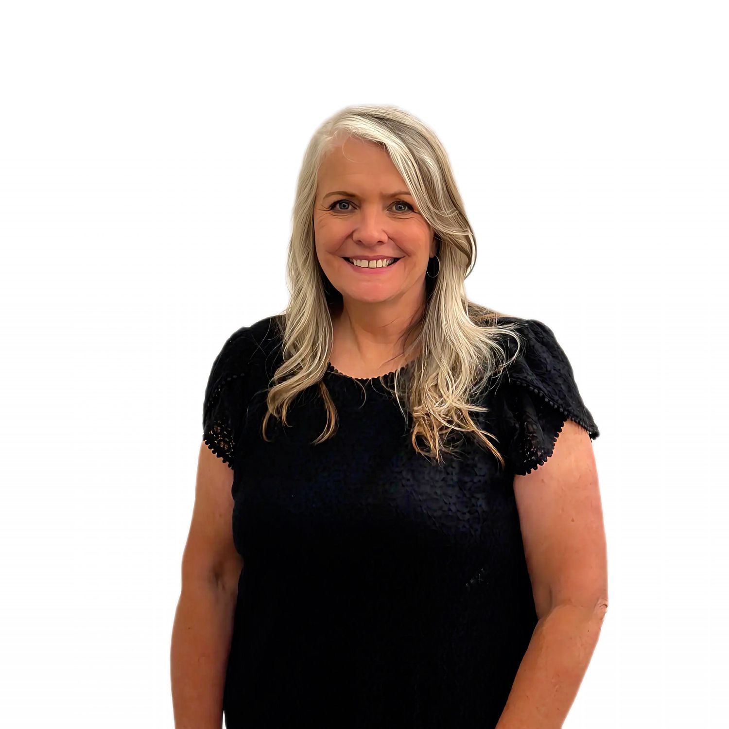 Smiling woman with long blonde hair wearing a black lace top, posing against a white background.