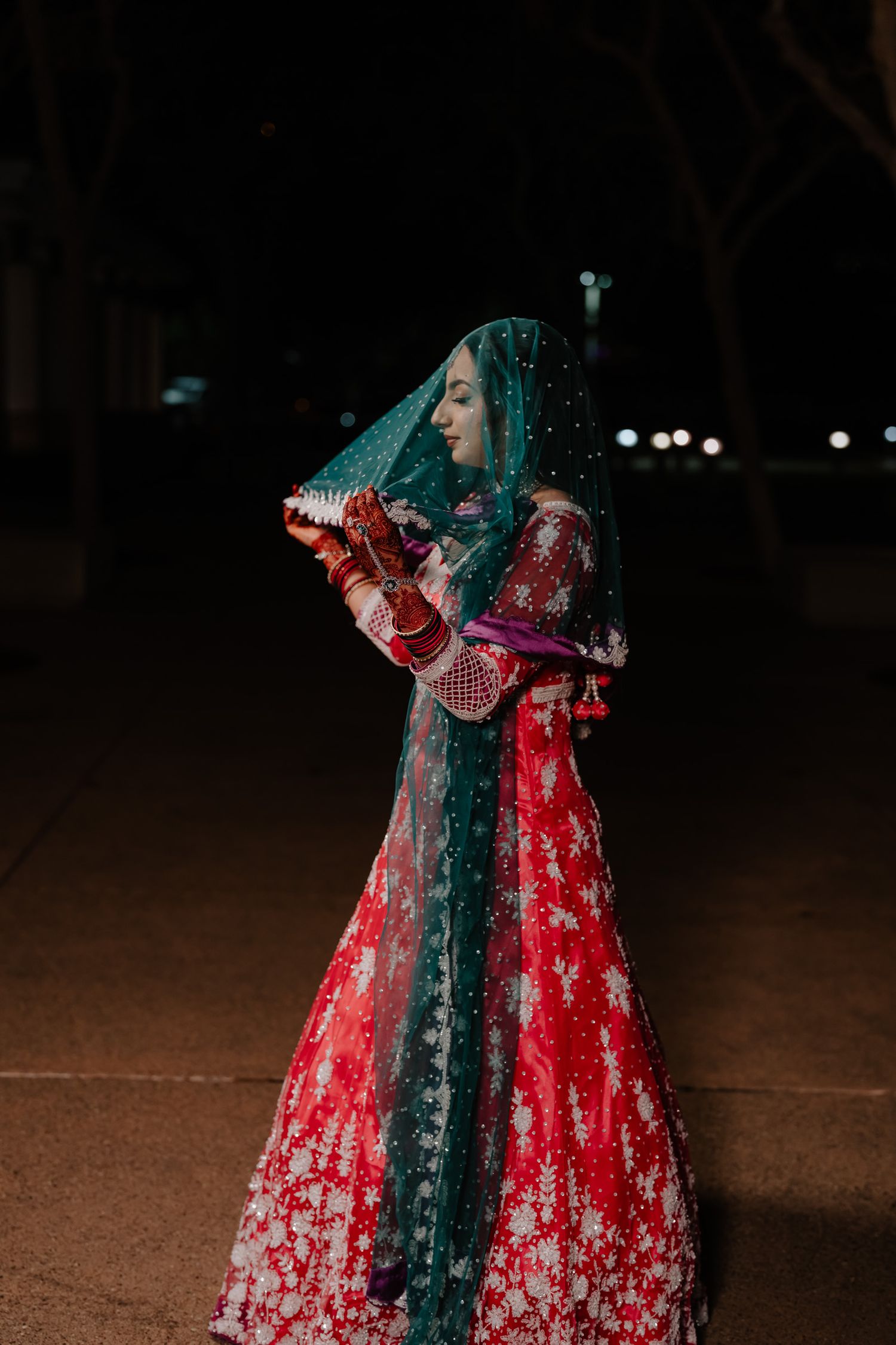A series of romantic photos showing a couple in traditional Indian wedding outfits with red and teal colors.