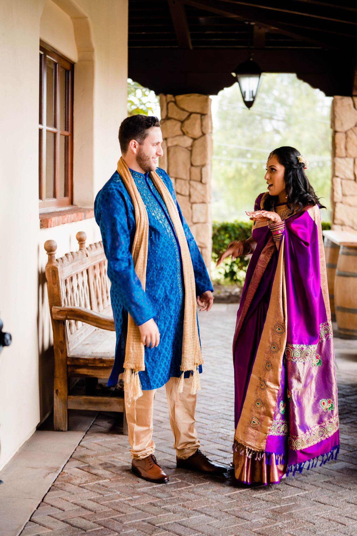 A couple in traditional South Asian attire shares candid moments on a stone porch in a sequence of photos.