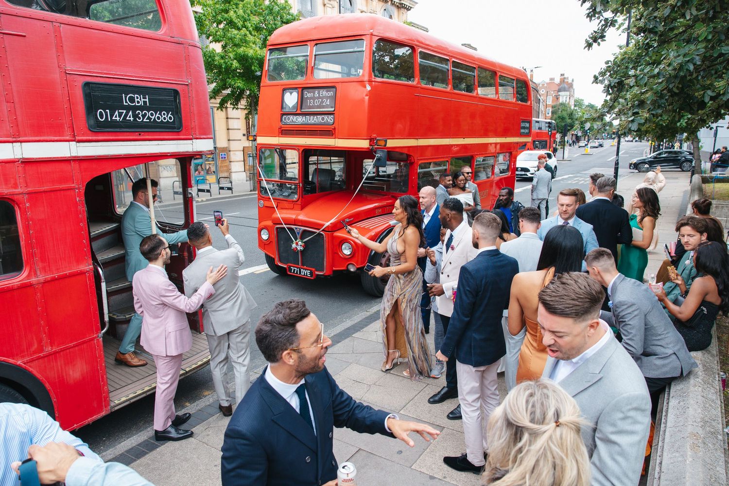 Guests gathered around an iconic London bus at the wedding.
