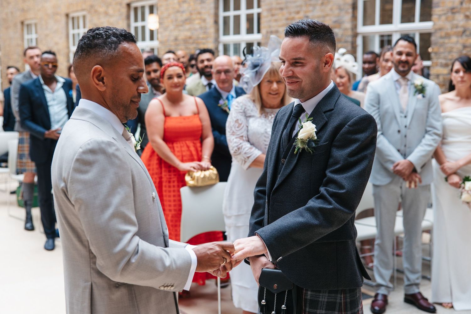 Grooms exchanging rings in the Atrium Room, Hackney Town Hall.