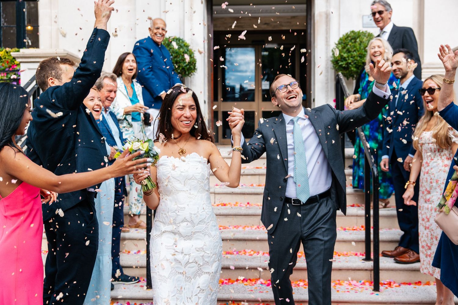 Confetti tunnel outside a town hall wedding