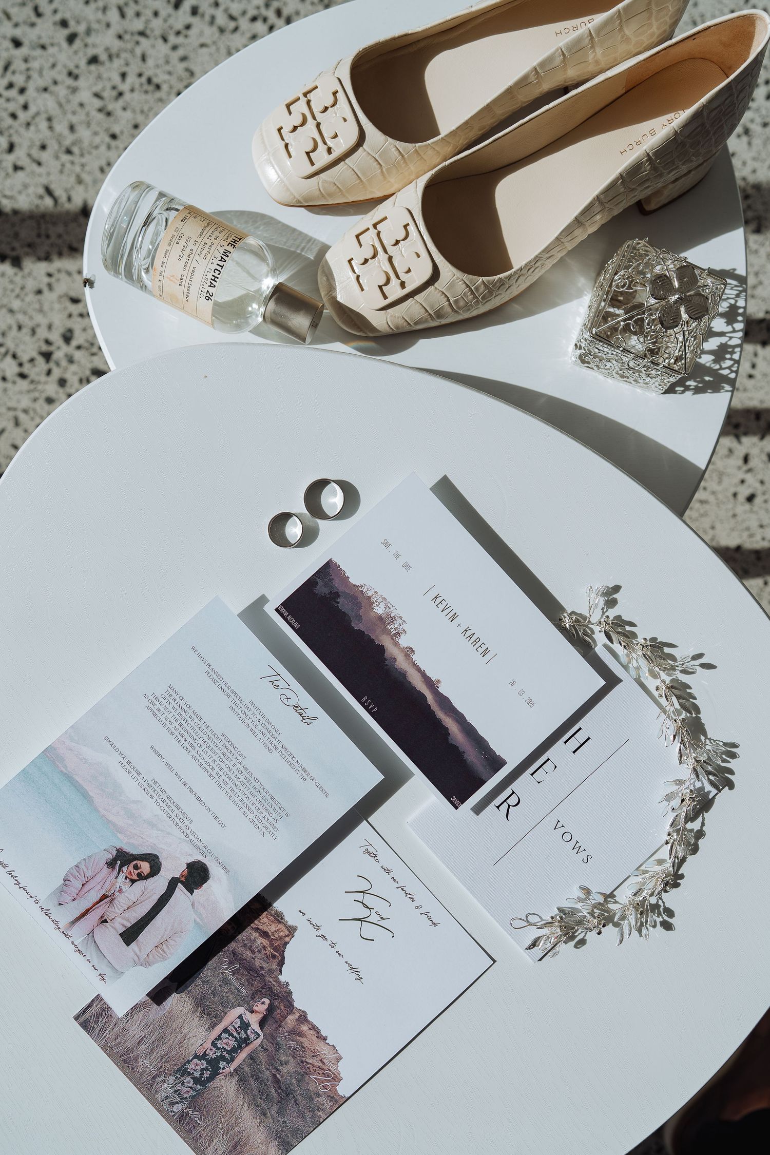 Wedding invitation suite with landscape photos and elegant white bridal shoes.