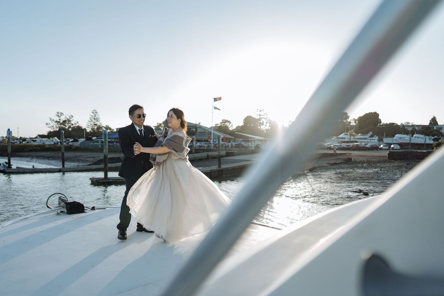 Waterfront wedding photography sequence with dramatic sunset lighting.