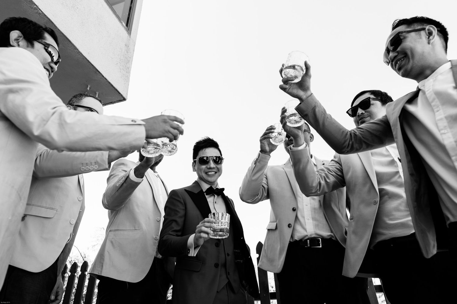 Black and white candid shots of wedding party members in formal attire.
