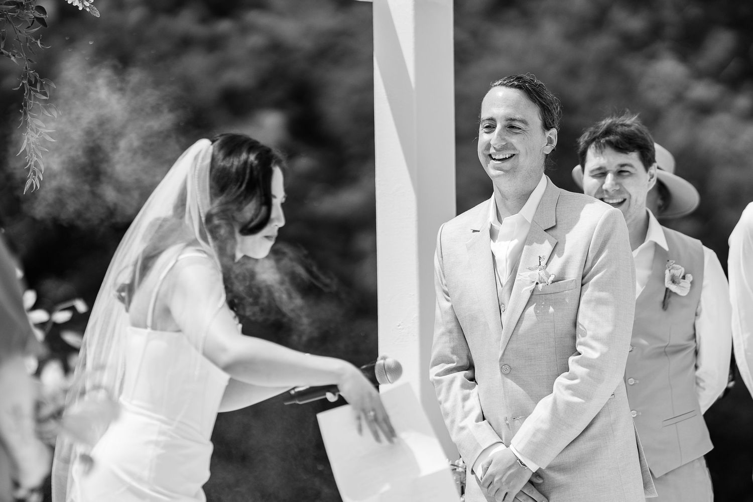A joyful moment captured during an outdoor wedding ceremony with laughter and celebration.