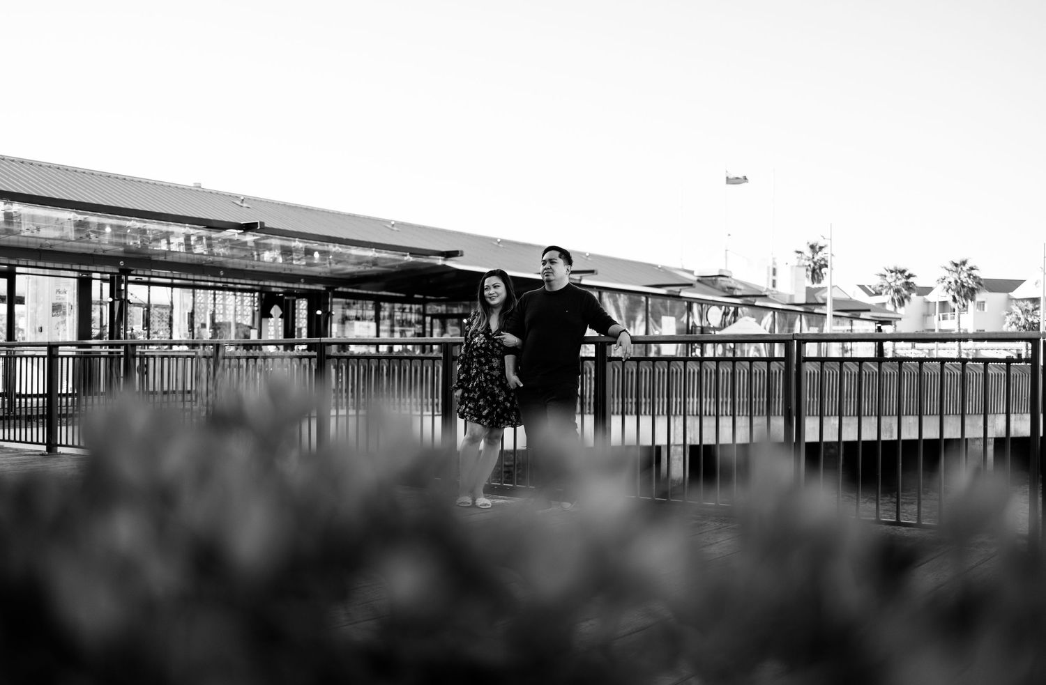 Silhouettes of people against a minimalist architectural backdrop.