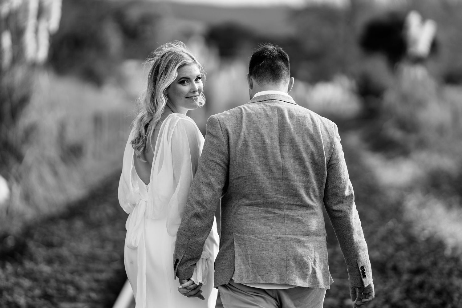 Romantic couple walking together through outdoor venue.