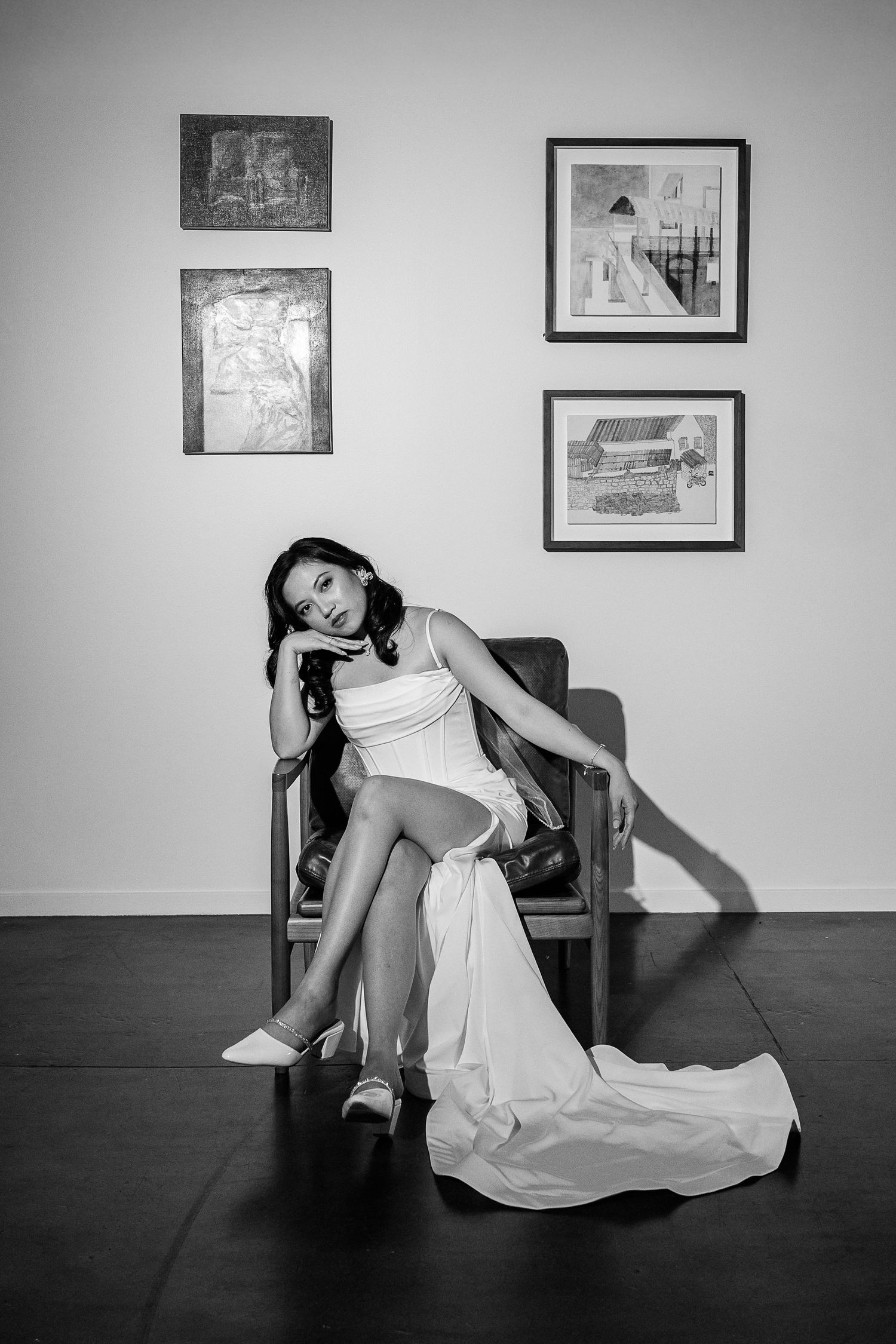 Dramatic black and white photo sequence showing movement and flowing white fabric in an indoor setting.