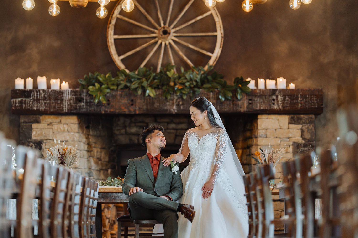 Wedding reception venue with rustic decor featuring wooden beams and warm lighting.