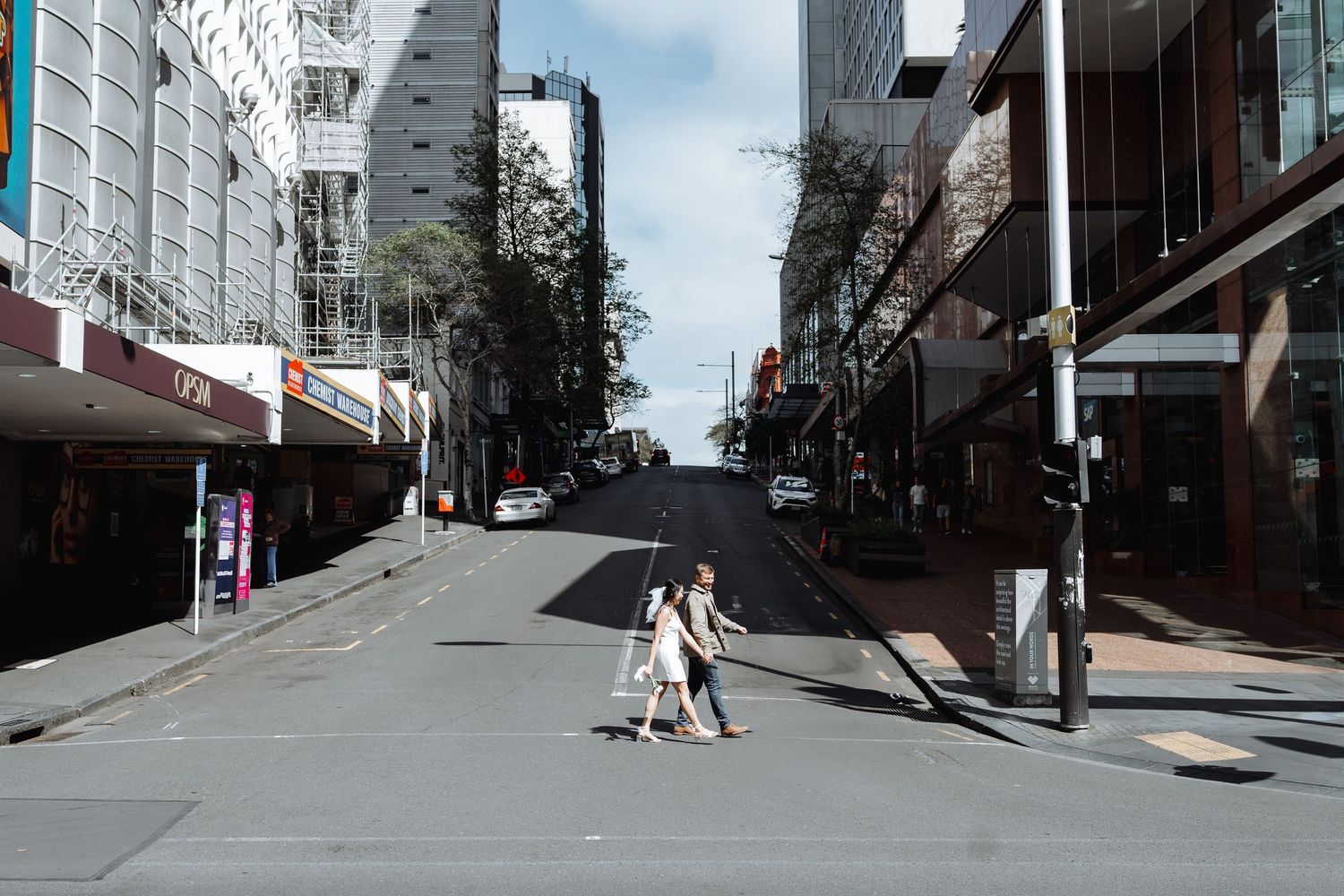 Wide angle view of empty city streets with modern buildings and clear skies.
