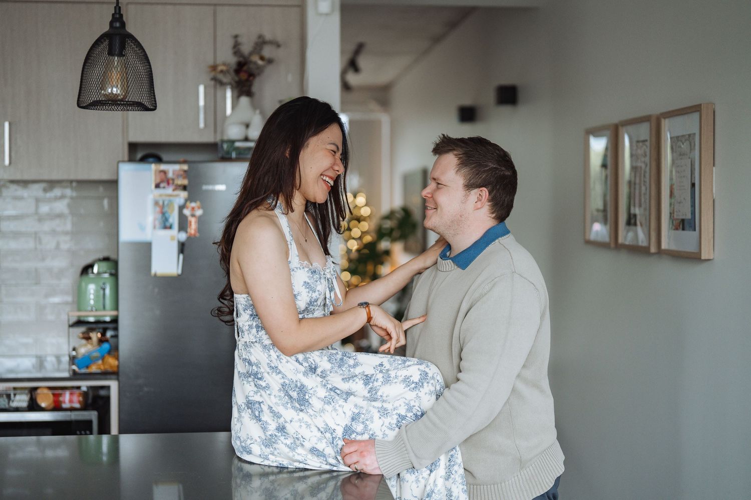 A couple shares playful moments while cooking in their kitchen.