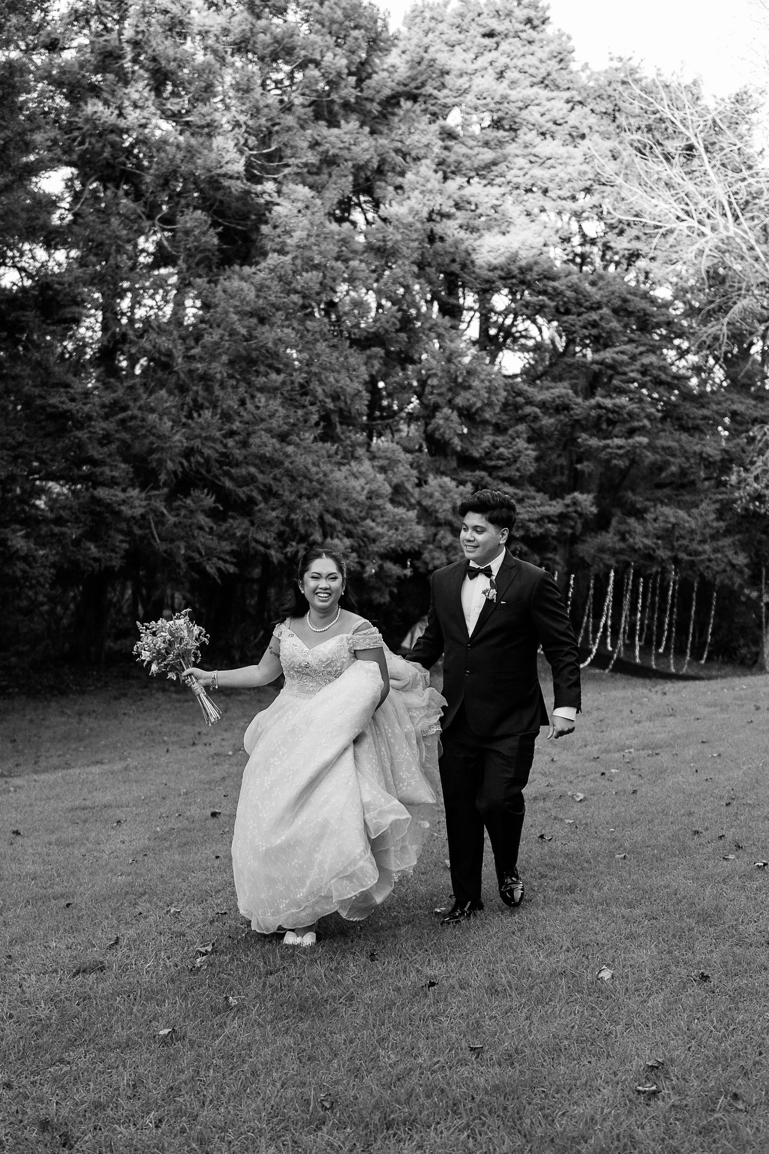 Black and white wedding photos captured in a scenic wooded area.
