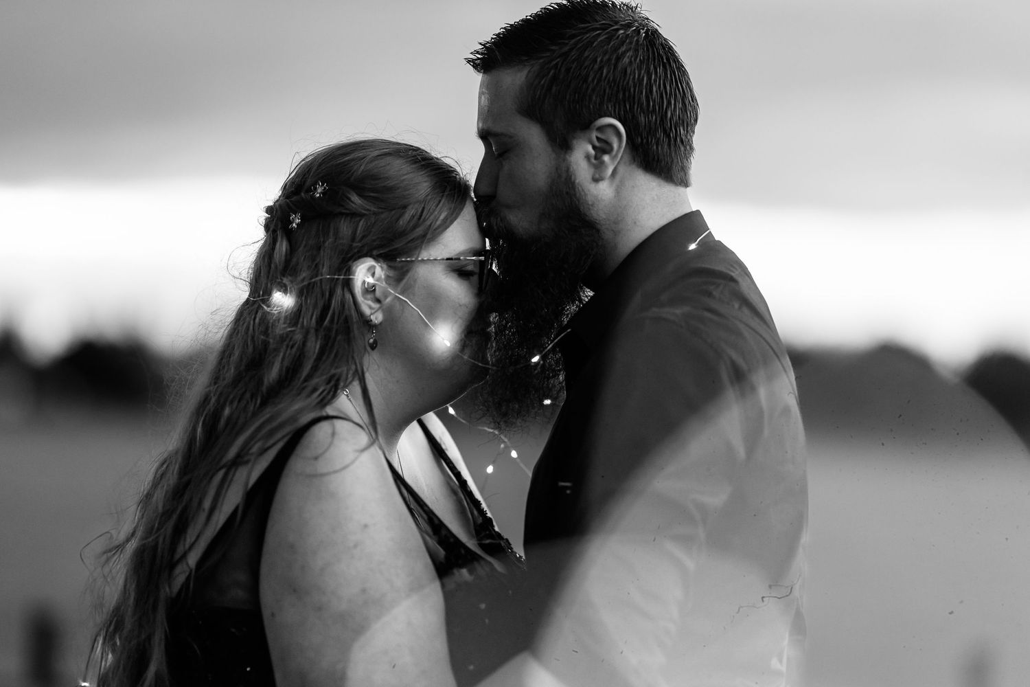 Black and white romantic silhouettes against a soft blurred background.