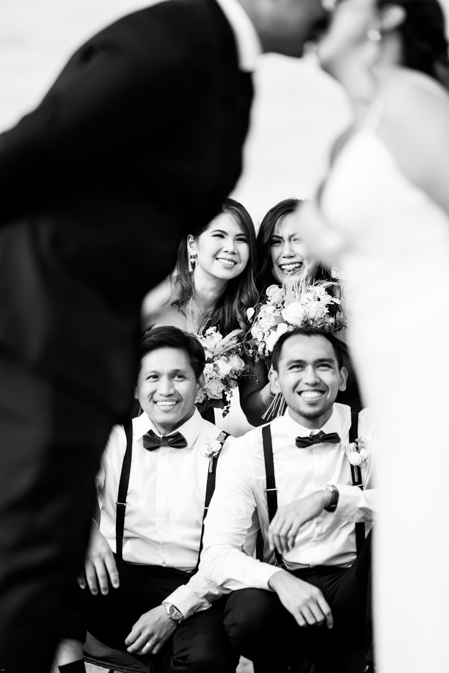 Black and white portraits of wedding party members laughing and wearing bow ties.