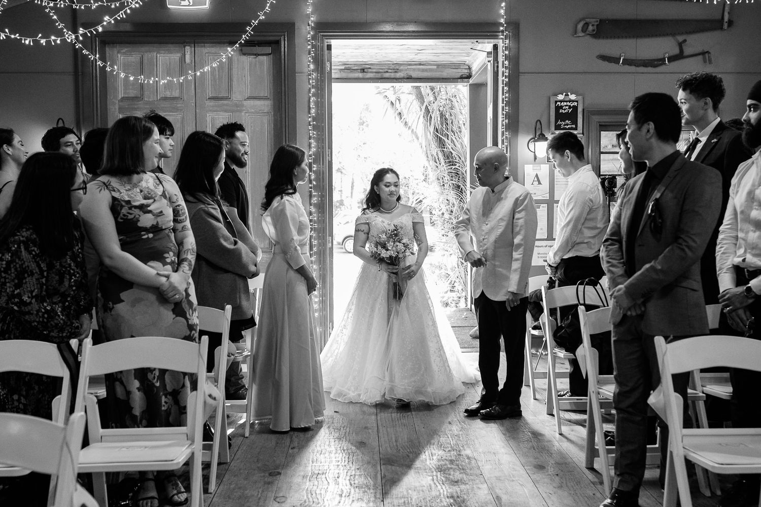 Black and white photo series capturing intimate wedding ceremony moments in a rustic venue.