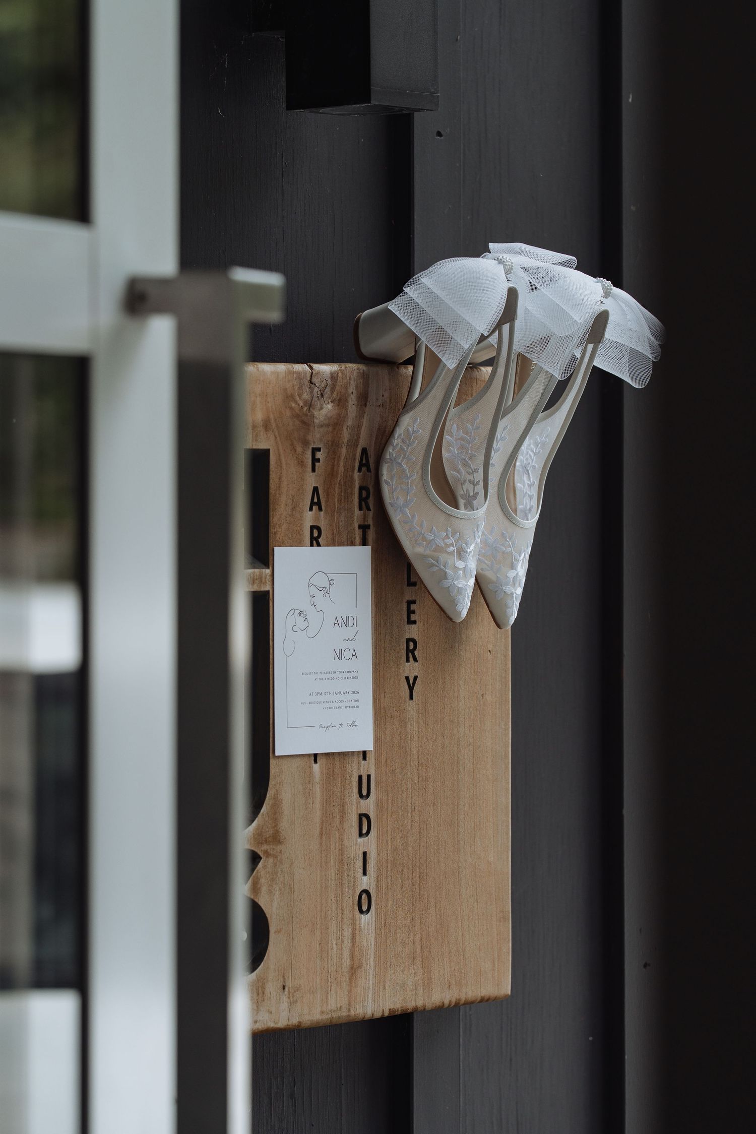 Paper tags with text hang from wooden pegs against a dark background.