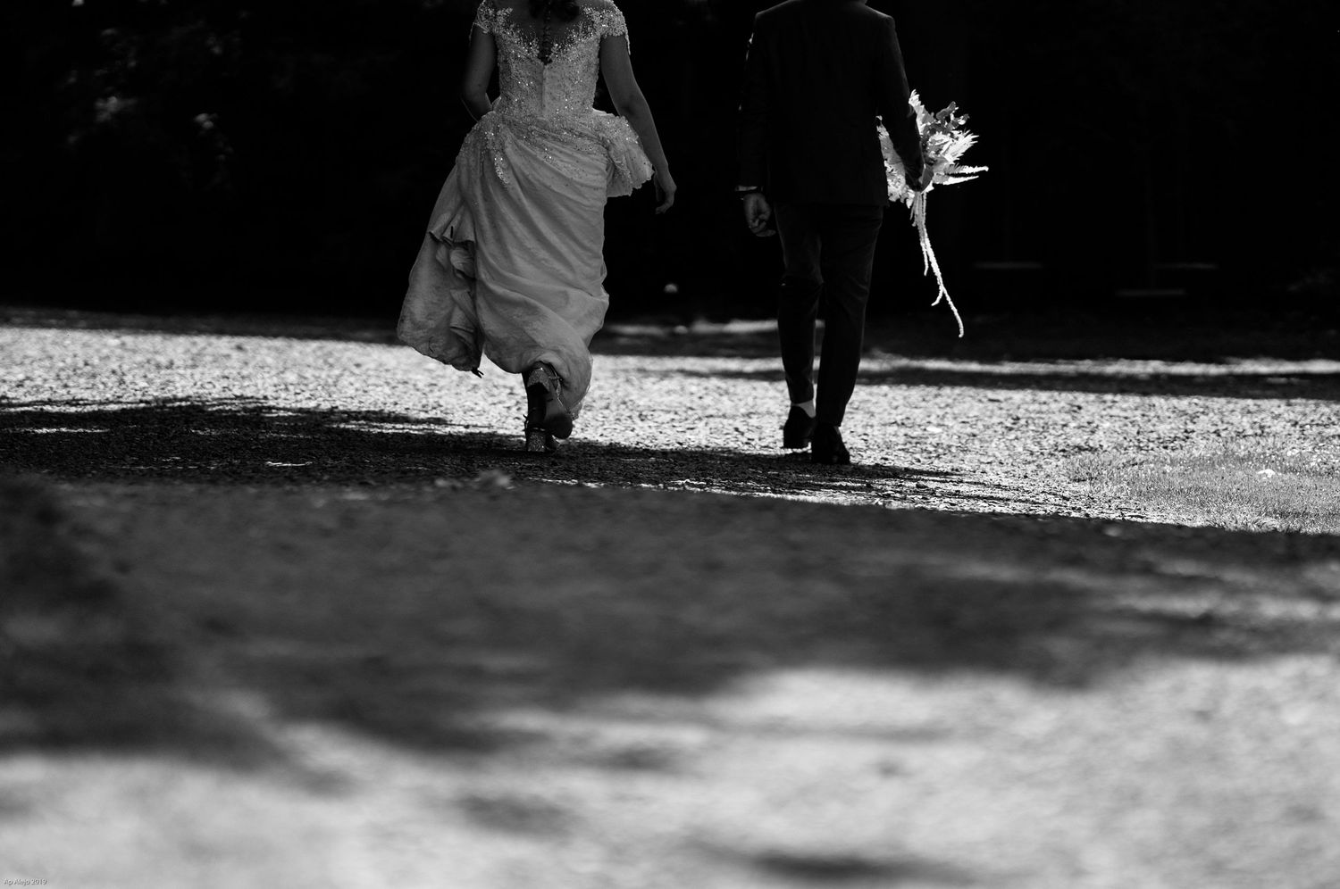 Black and white silhouettes of people walking in dramatic shadows.