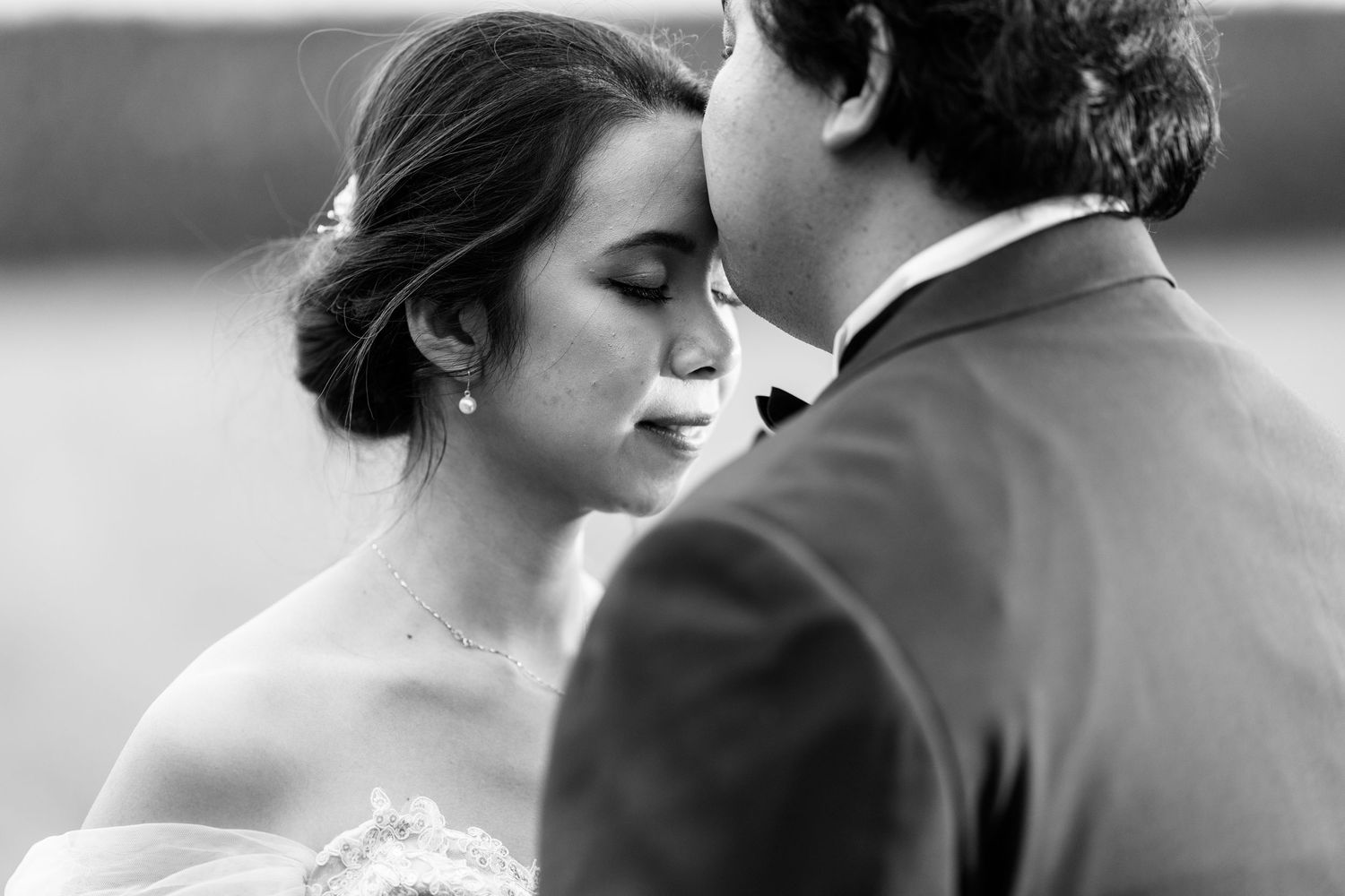 Romantic black and white wedding portraits showing intimate moments between newlyweds.