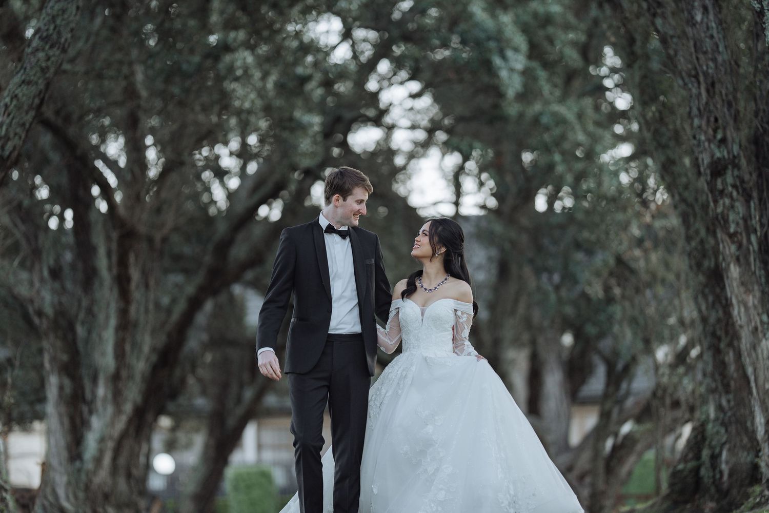 Couple shares romantic moments in an elegant outdoor wedding photoshoot.
